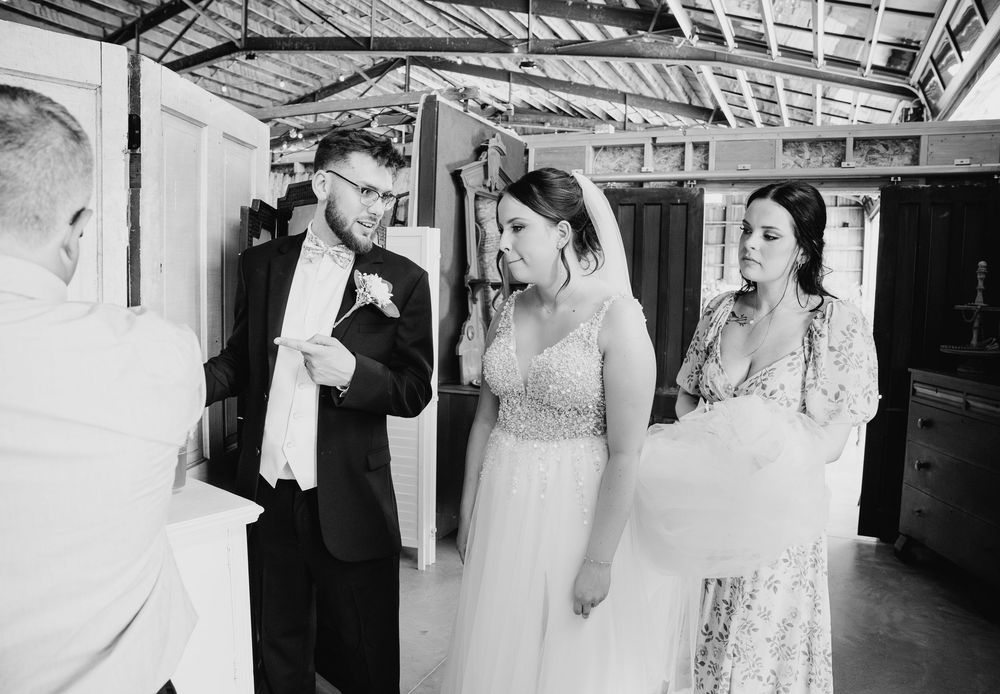 Black and white photo collage of wedding moments showing dress details, embraces, and romantic poses.