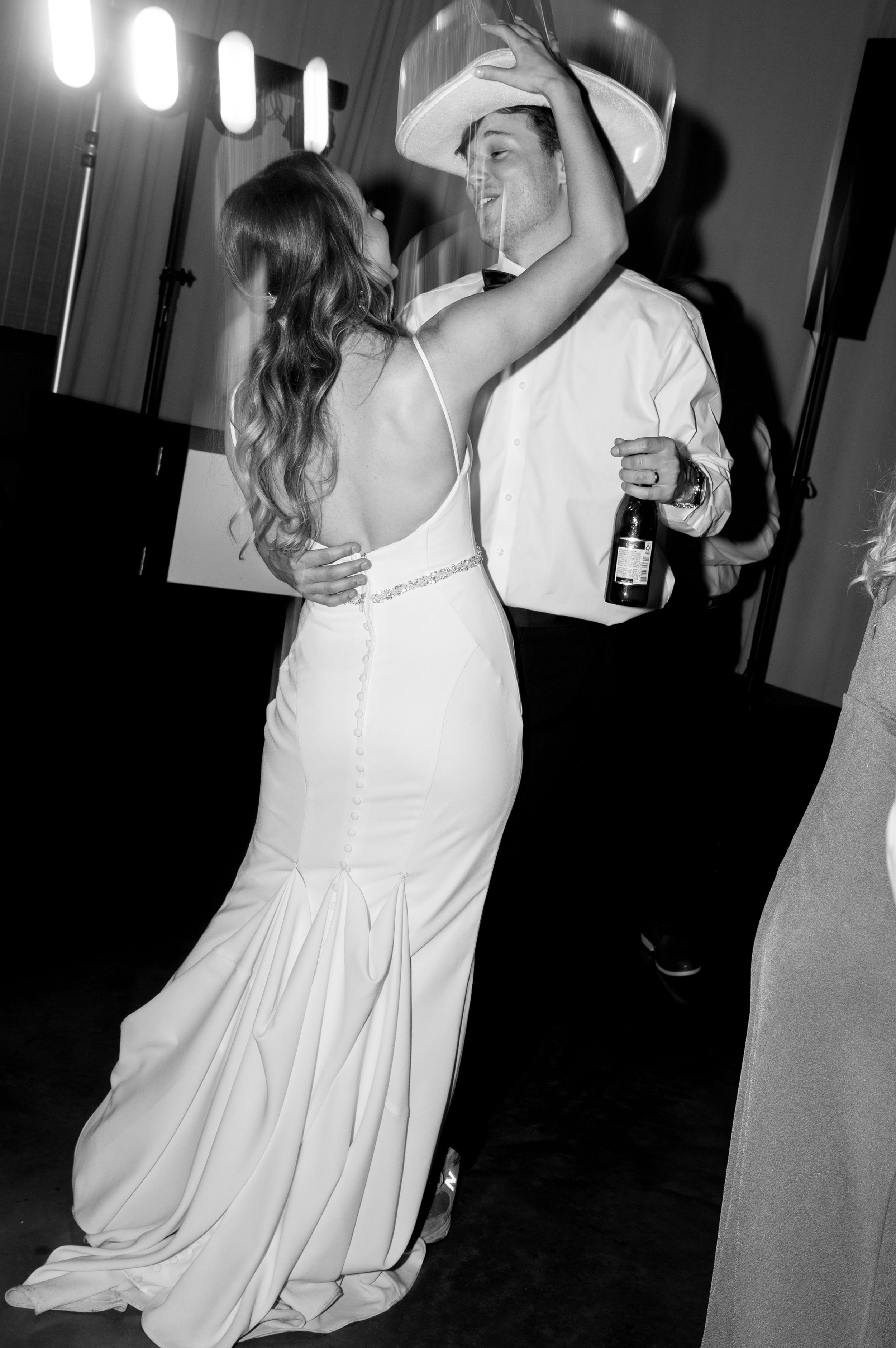 Black and white photos of wedding reception dancing with flowing white dress movements.