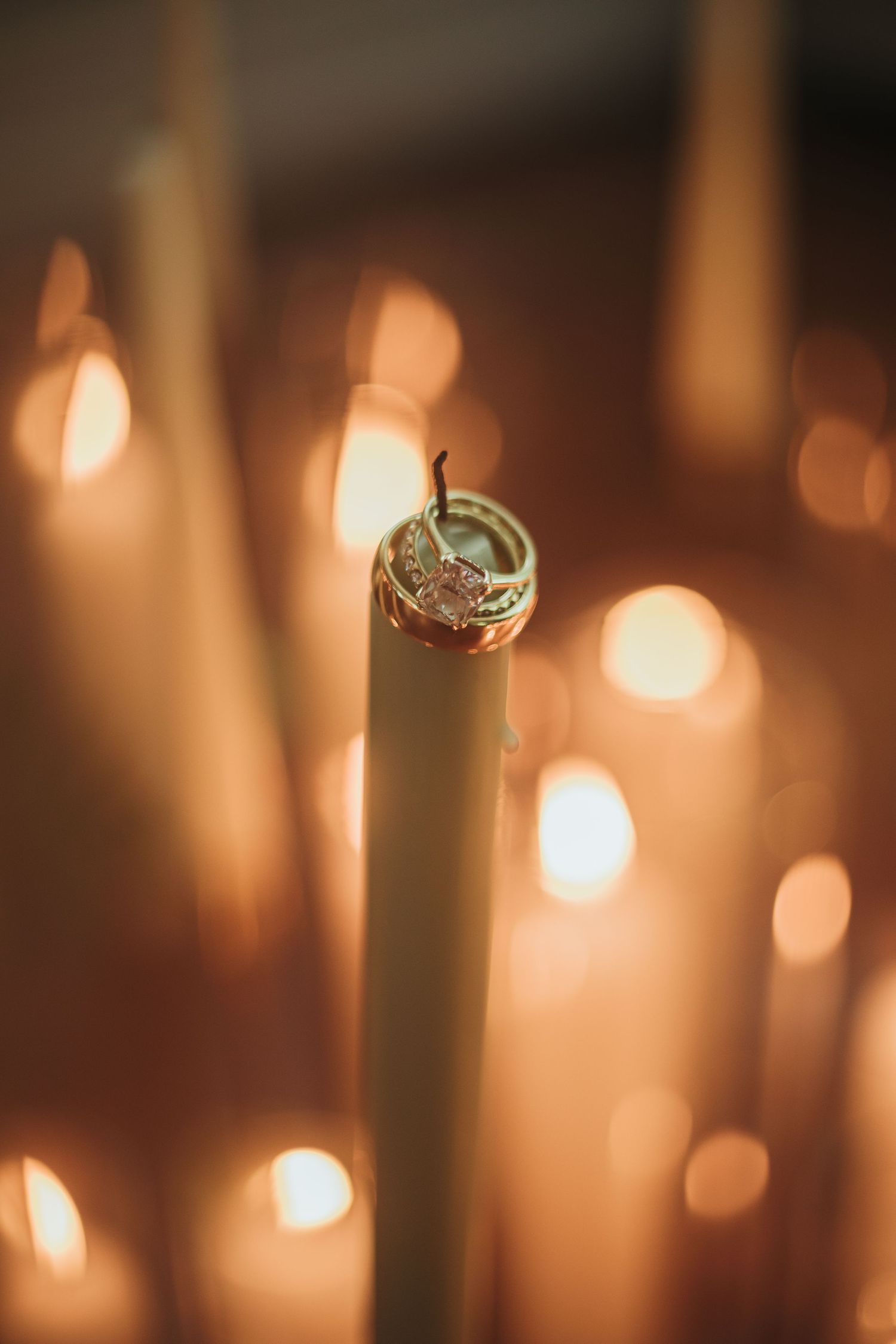 Wedding stack rests on candlestick.