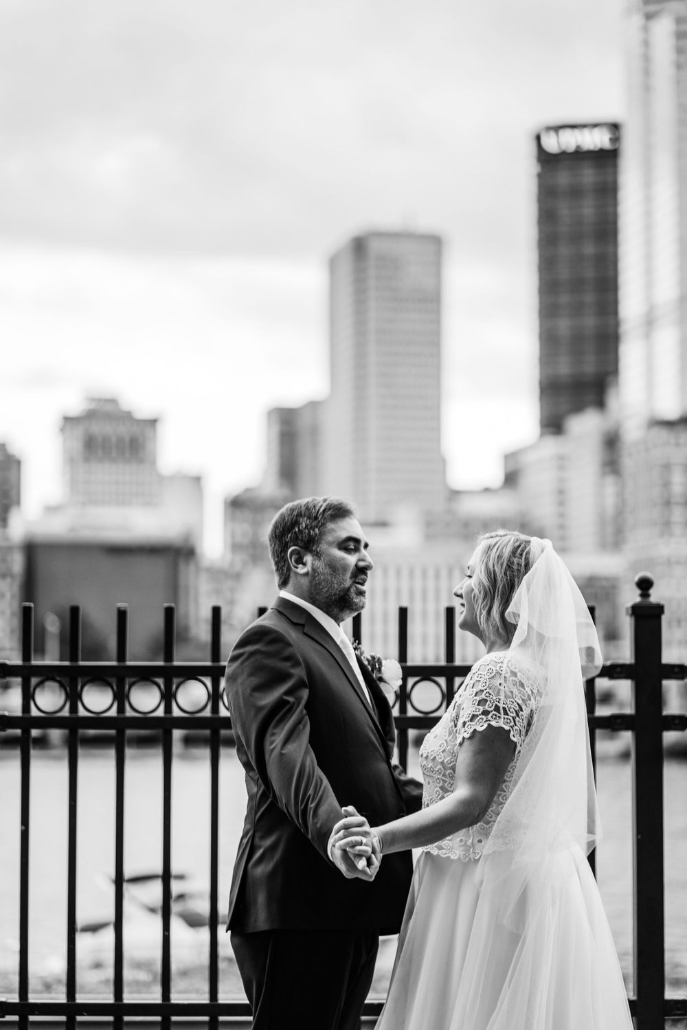 Couple facing each other in front of Pittsburgh's skyline, view from Pittsburgh's Grand Concourse | Shannon Konek, Pittsburgh Photographer