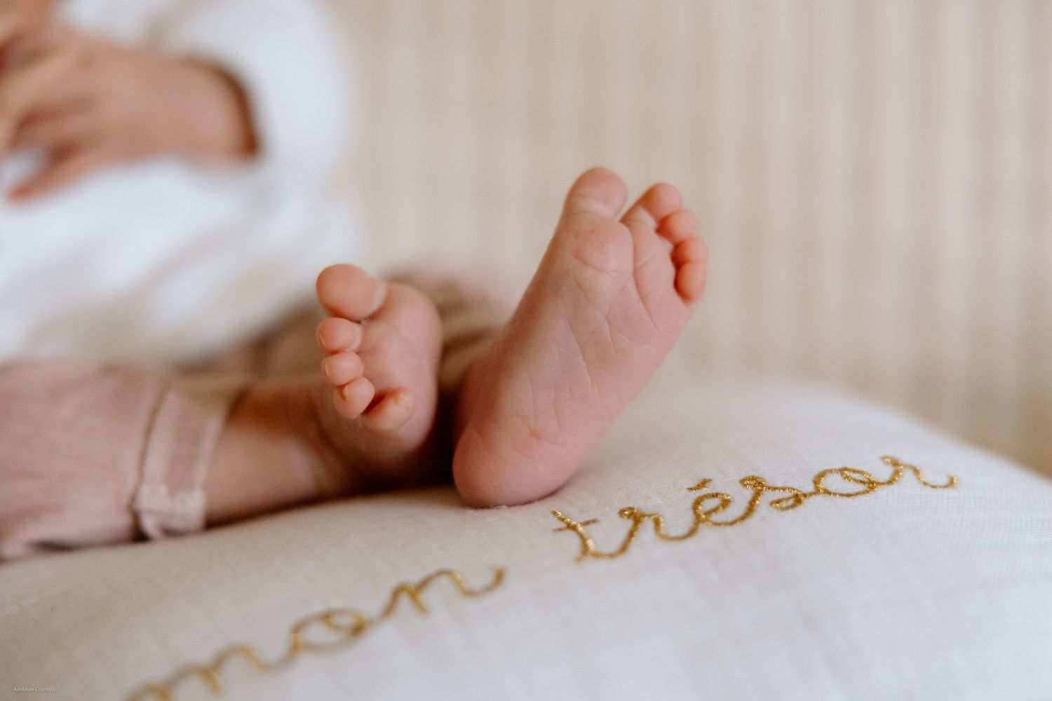 A close-up of baby feet with a softly blurred background, highlighting the delicate and precious details of early childhood.