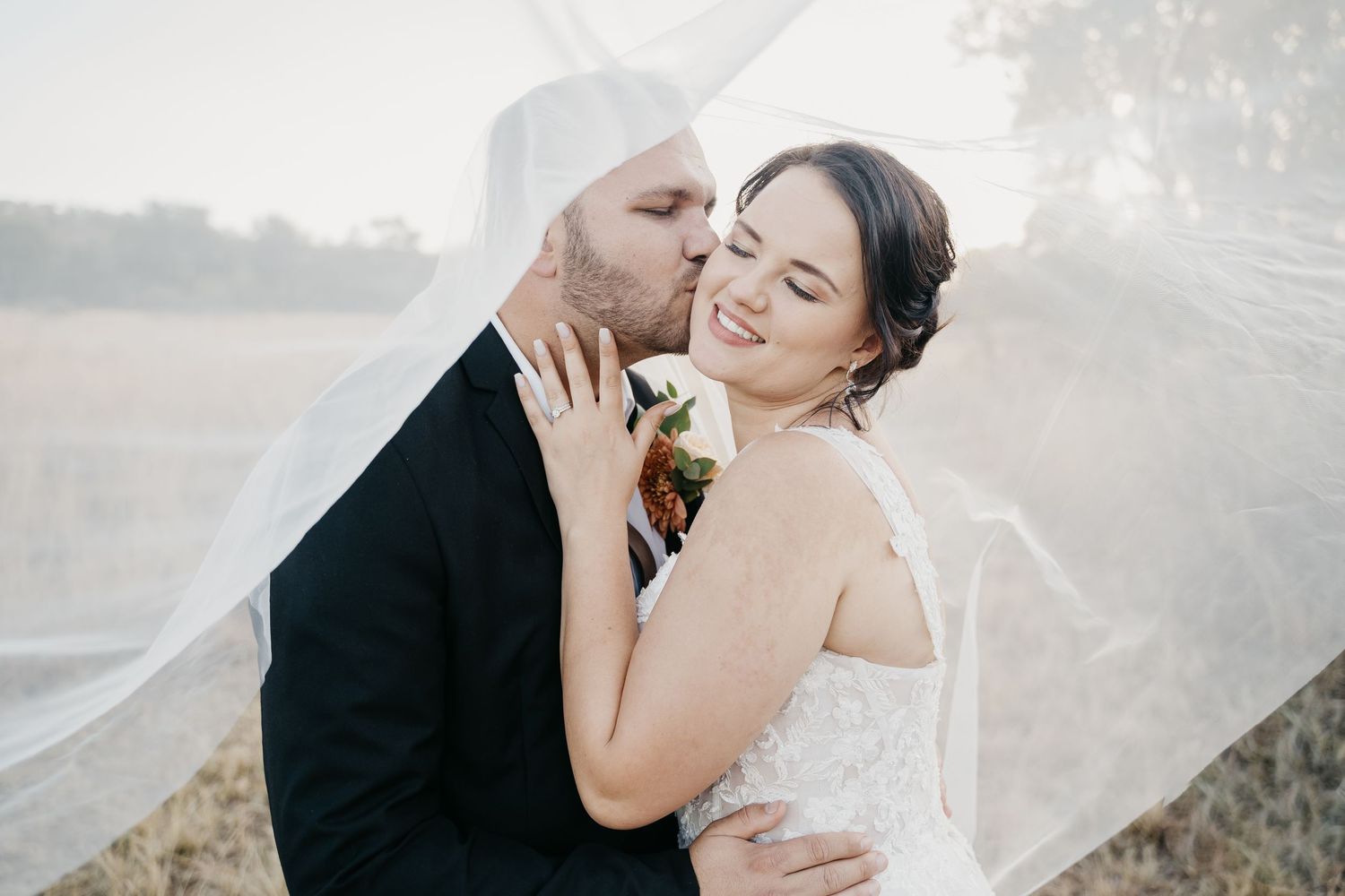 bride an groom sharing a moment underneath the veil on their safari wedding at Kuthaba Bush Lodge in South Africa