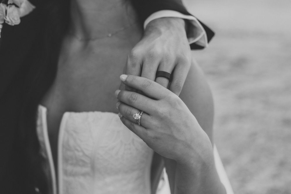 A series of black and white photos showing hands exchanging wedding rings during a marriage ceremony.