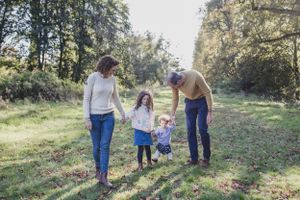 A family enjoying quality time together outdoors on a sunny path surrounded by trees.
Family photography, Suffolk.