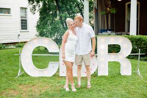 Large decorative white letters spelling text arranged outdoors on grass.