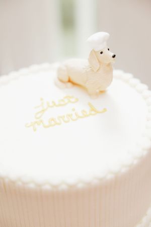 White frosted cupcake with delicate sugar decorations on top.
