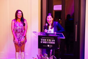 Branding and event session with host on stage at an elegant event with purple mood lighting.