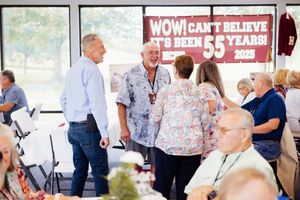 Guests mingle and socialize at a festive indoor celebration event.