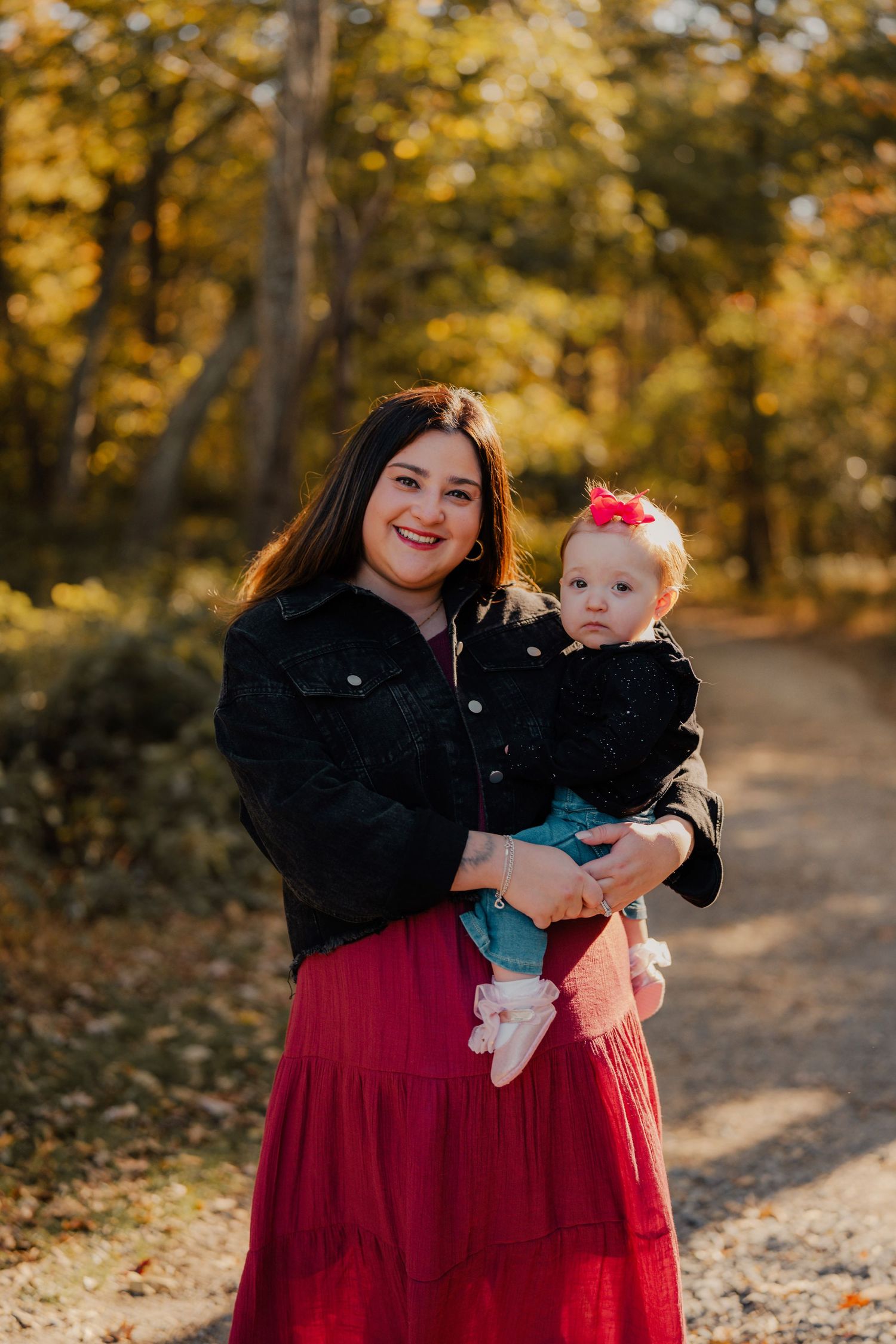 A touching autumn portrait on a tree-lined path with golden fall foliage.