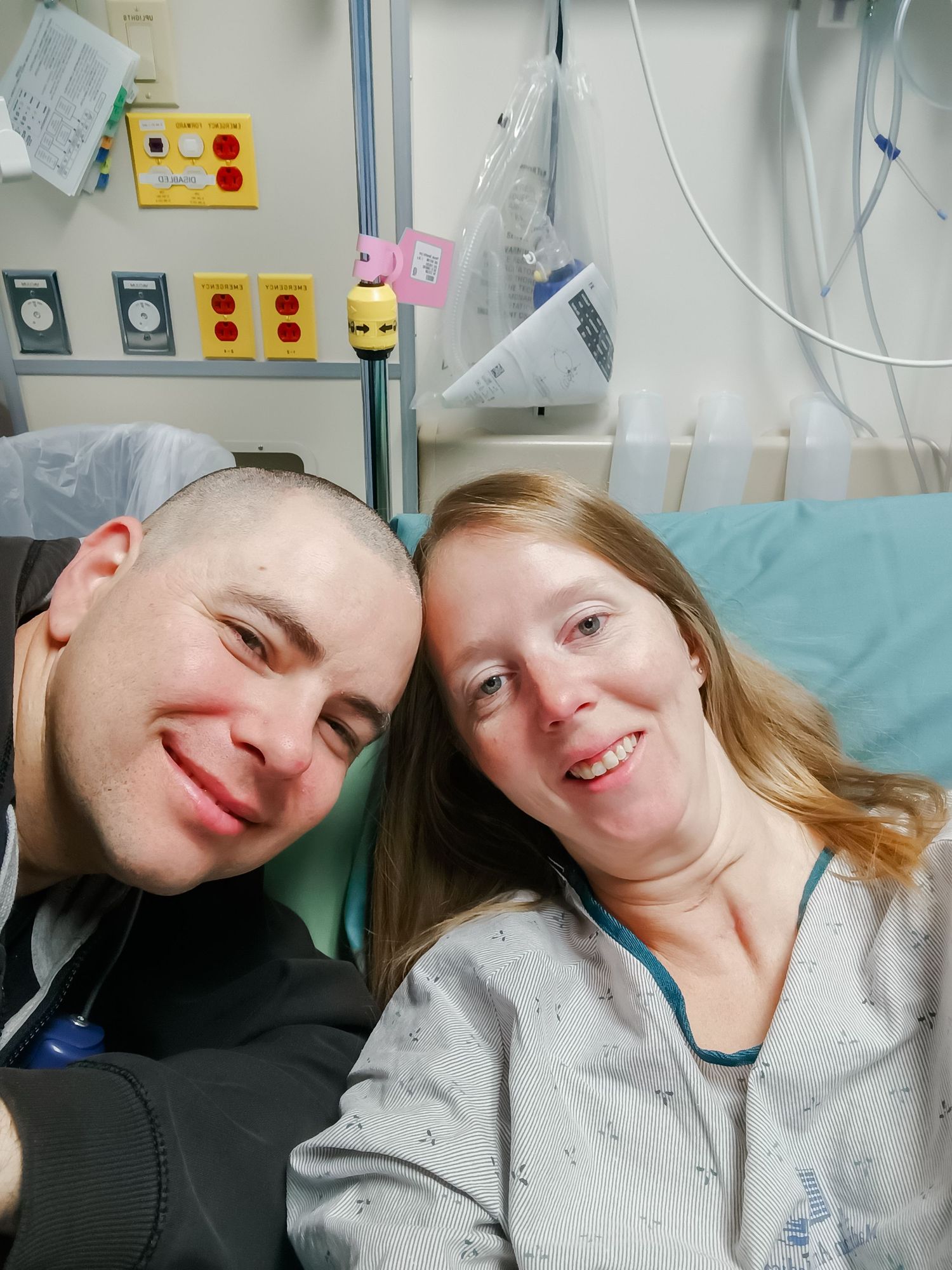 Medical facility setting showing two people sharing a supportive moment.