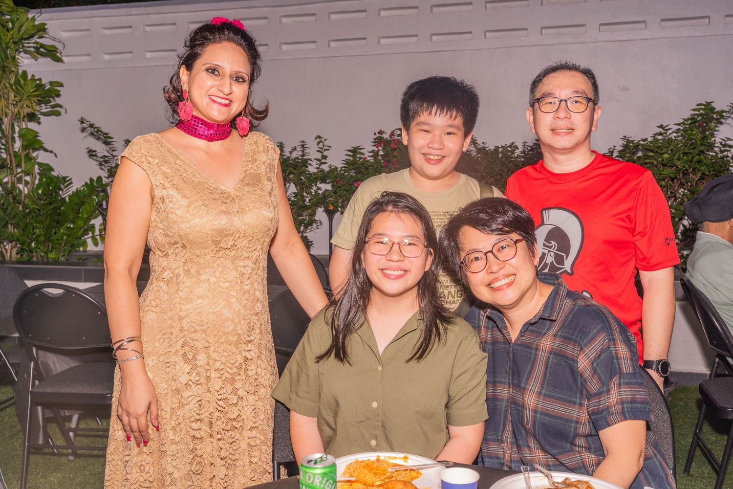 Family group posed together outdoors for evening portrait.