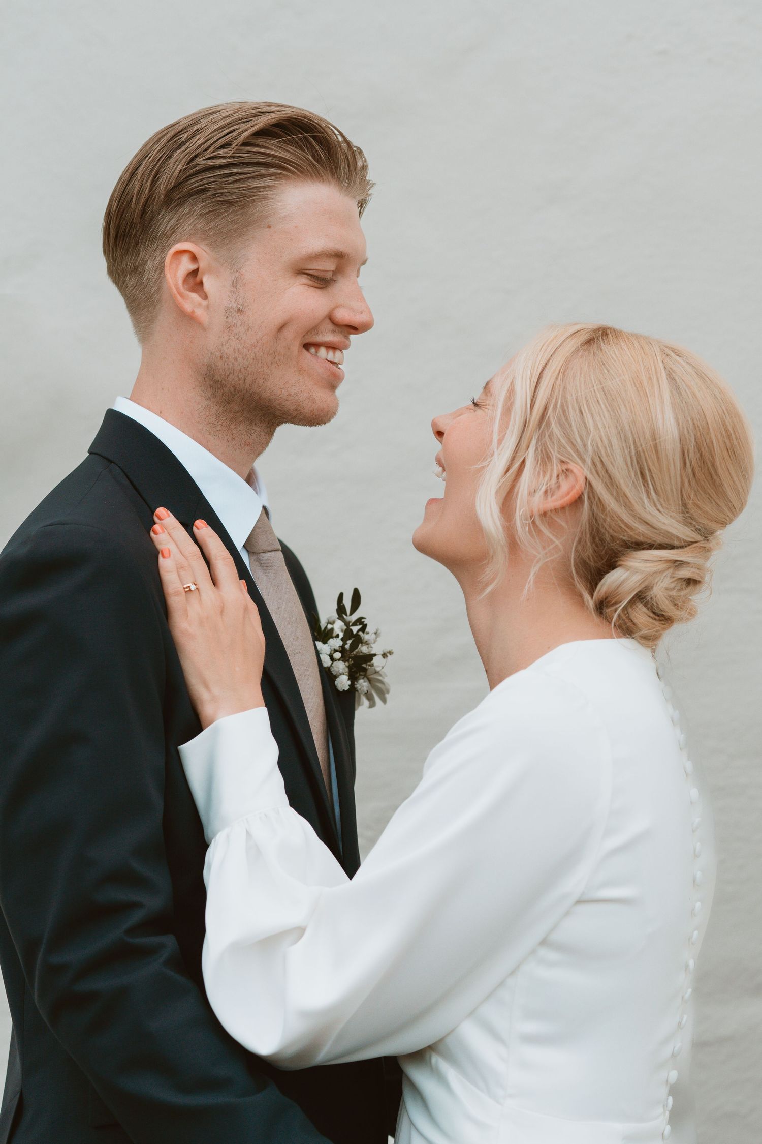 Intimate wedding moment captured in elegant black and white with couple in formal attire.
