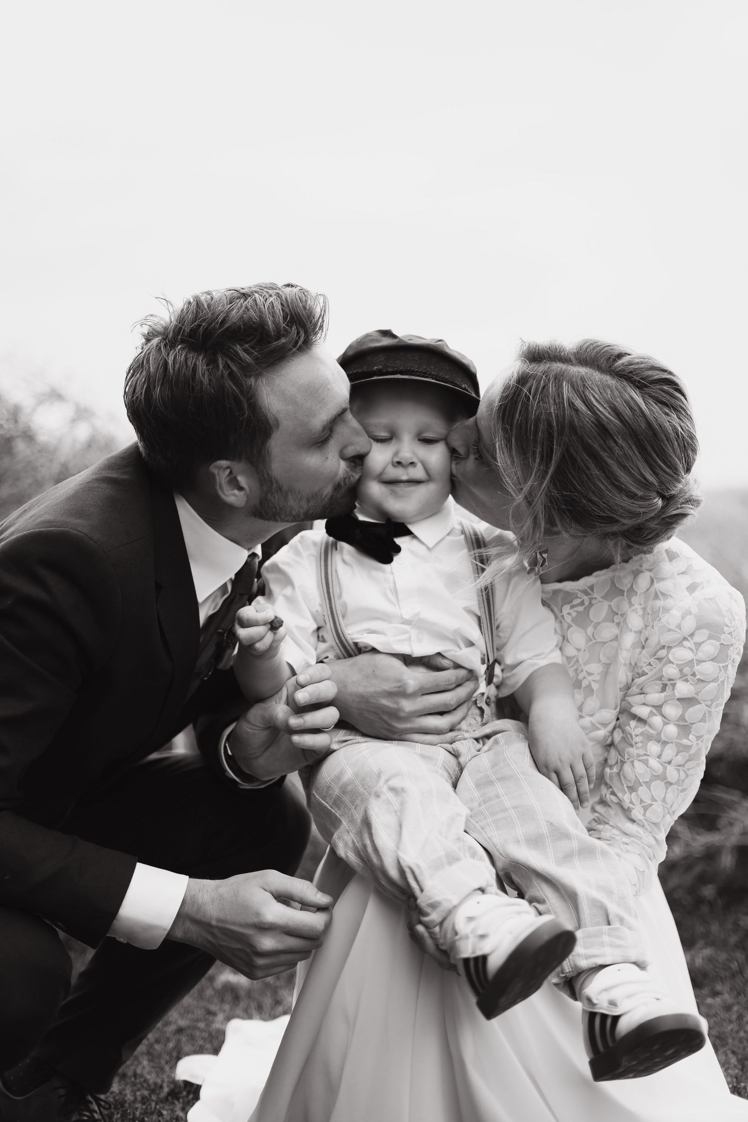 A tender family moment captured in black and white during a wedding celebration.