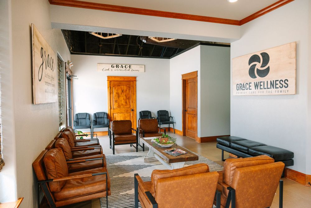 Modern wellness center waiting room with brown leather chairs and wooden accents creating a warm, inviting atmosphere.