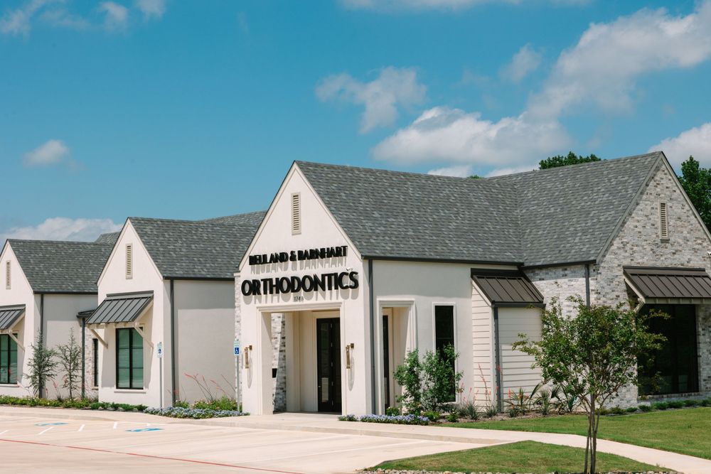 Orthodontics office exterior featuring contemporary farmhouse architecture with peaked rooflines.