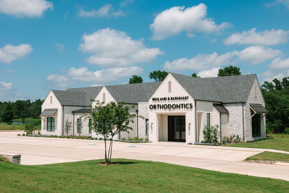 Modern farmhouse-style medical office building with grey roof and white exterior.