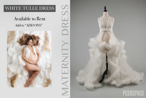 Dramatic white tulle maternity dress with voluminous skirt and flowing train.