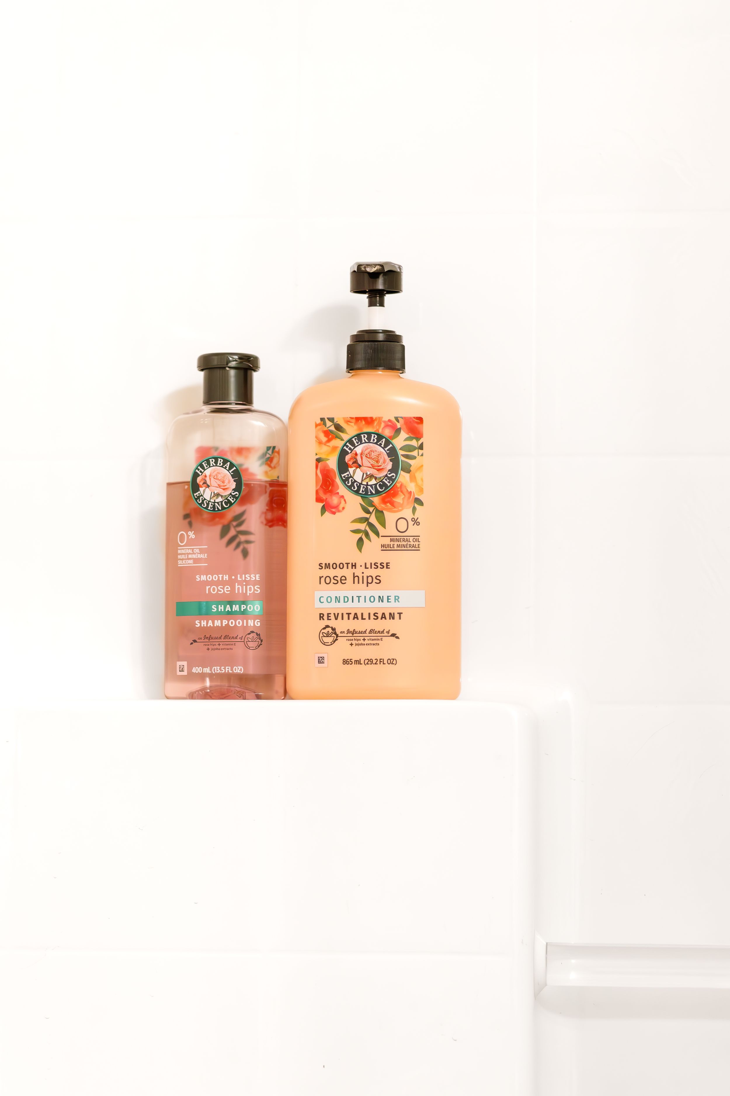 Two colorful Herbal Essences shampoo bottles displayed against white background.