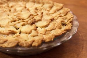 Homemade apple pie with lattice crust baked in glass pie dish.