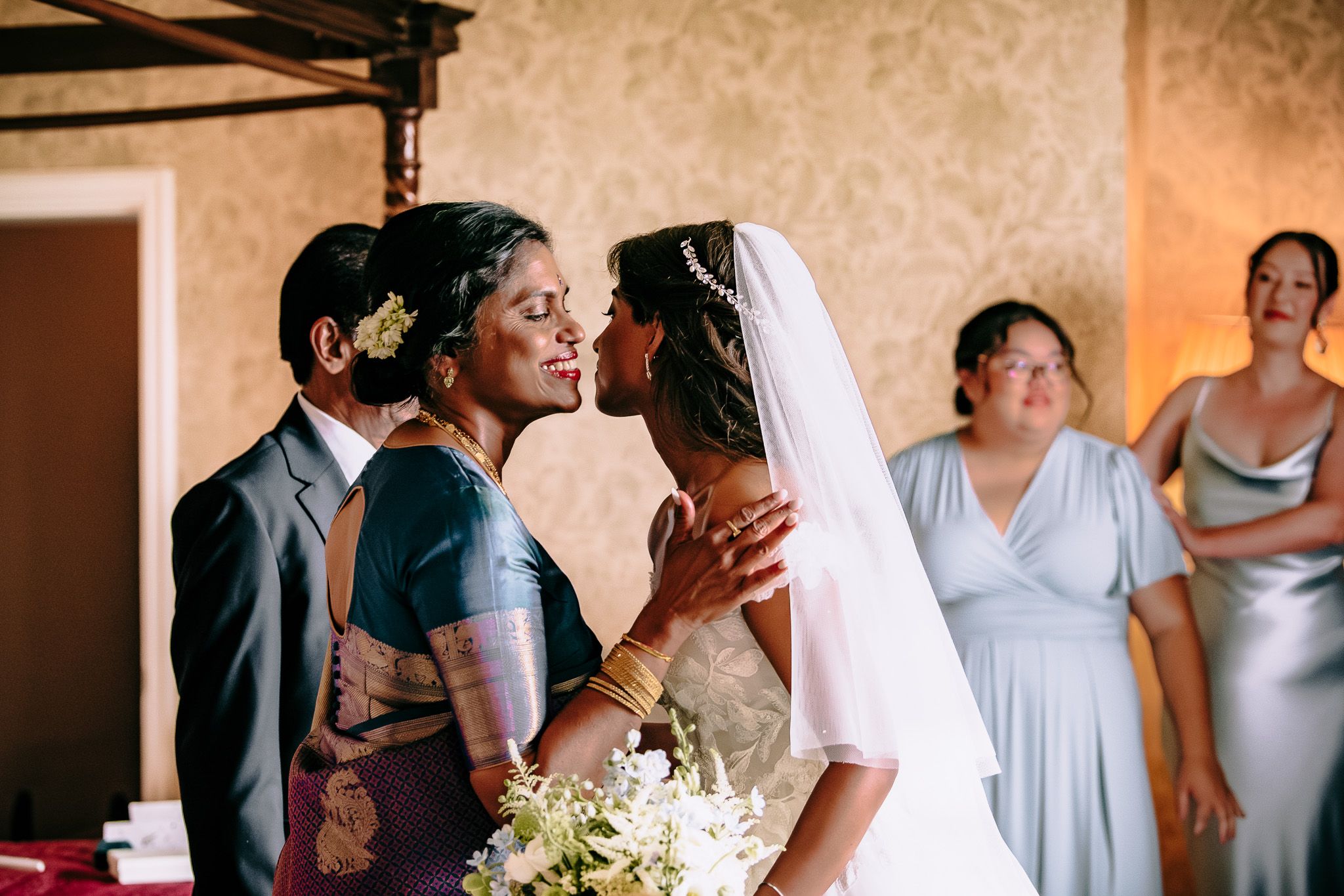 Wedding party members in light blue dresses and formal attire during celebration.