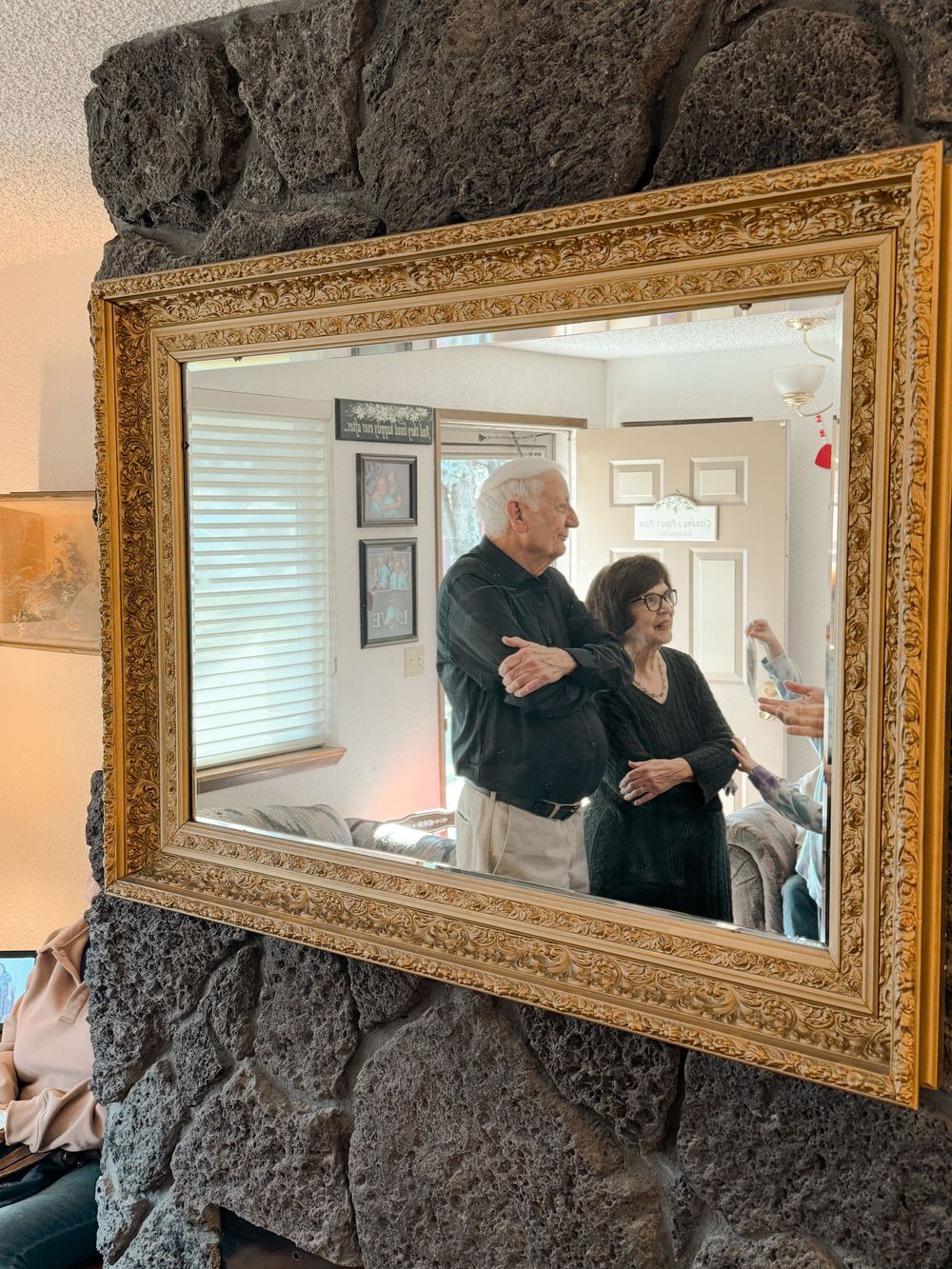 Creative shot of a couple through a mirror in a cozy indoor space