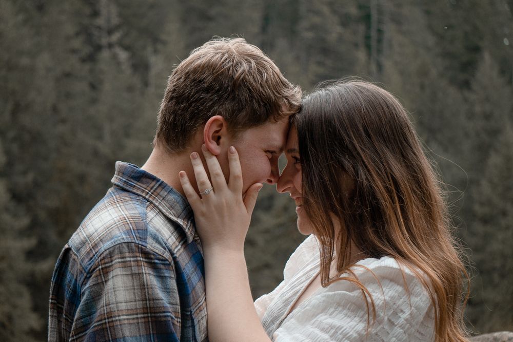 Intimate moment between couple standing close in the forest during outdoor couples session in Salem OR