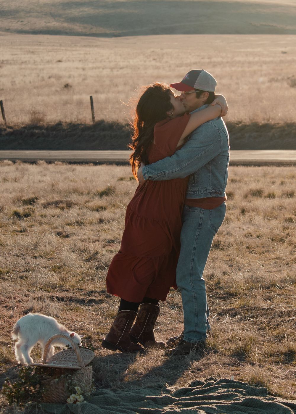 Couple embracing warmly during a fall photo session in an open field near Tri-Cities WA