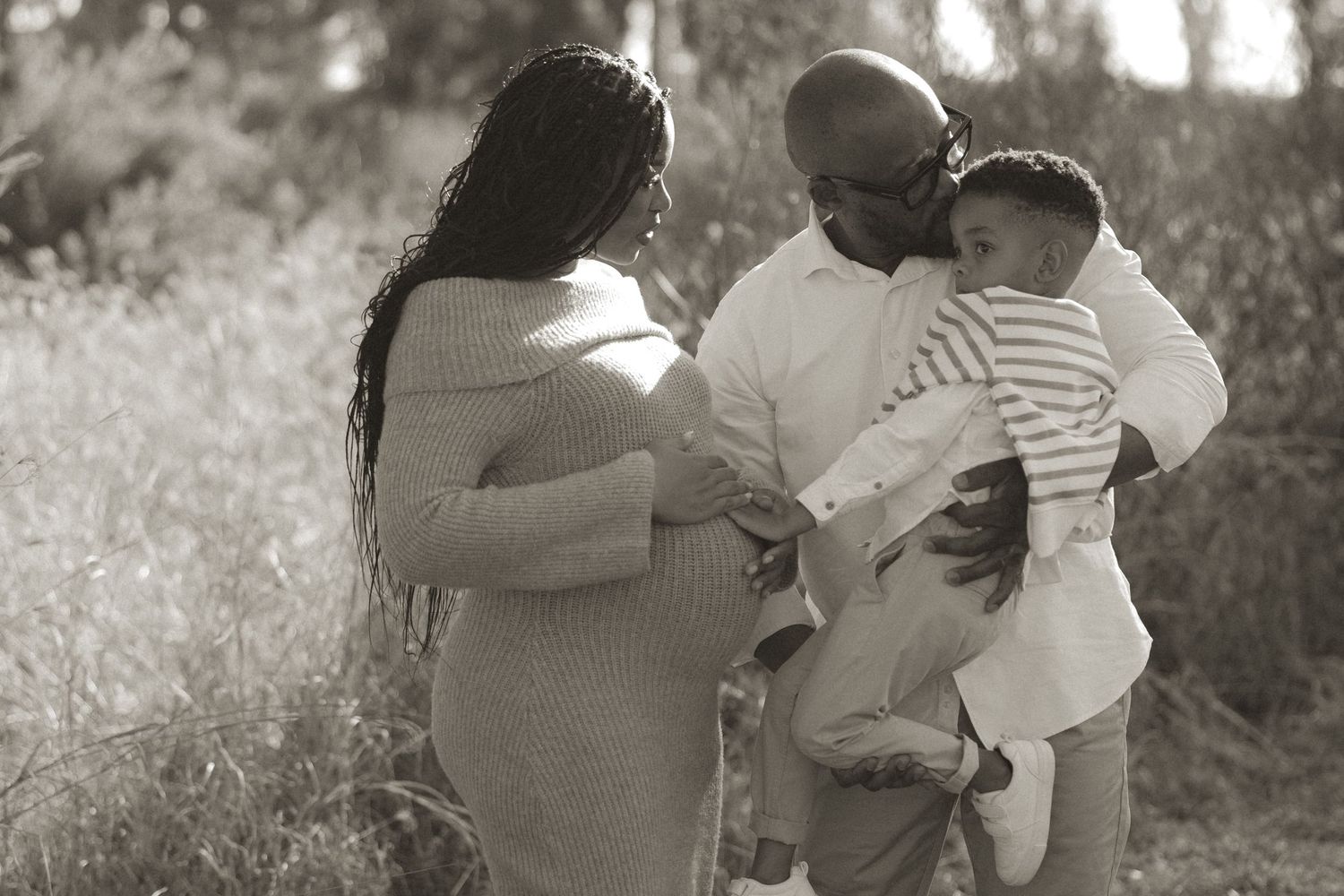 Black and white photo series showing intimate moments between two people embracing in an outdoor setting.