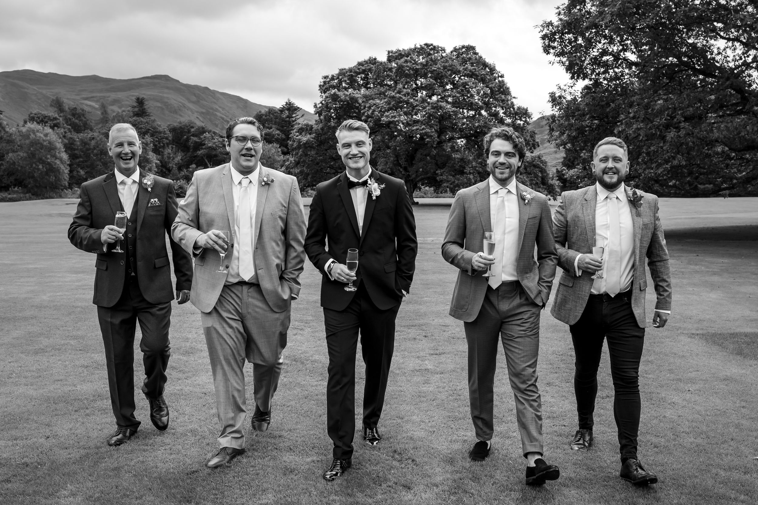 wedding photography in Cumbria - grooms men walking the grounds