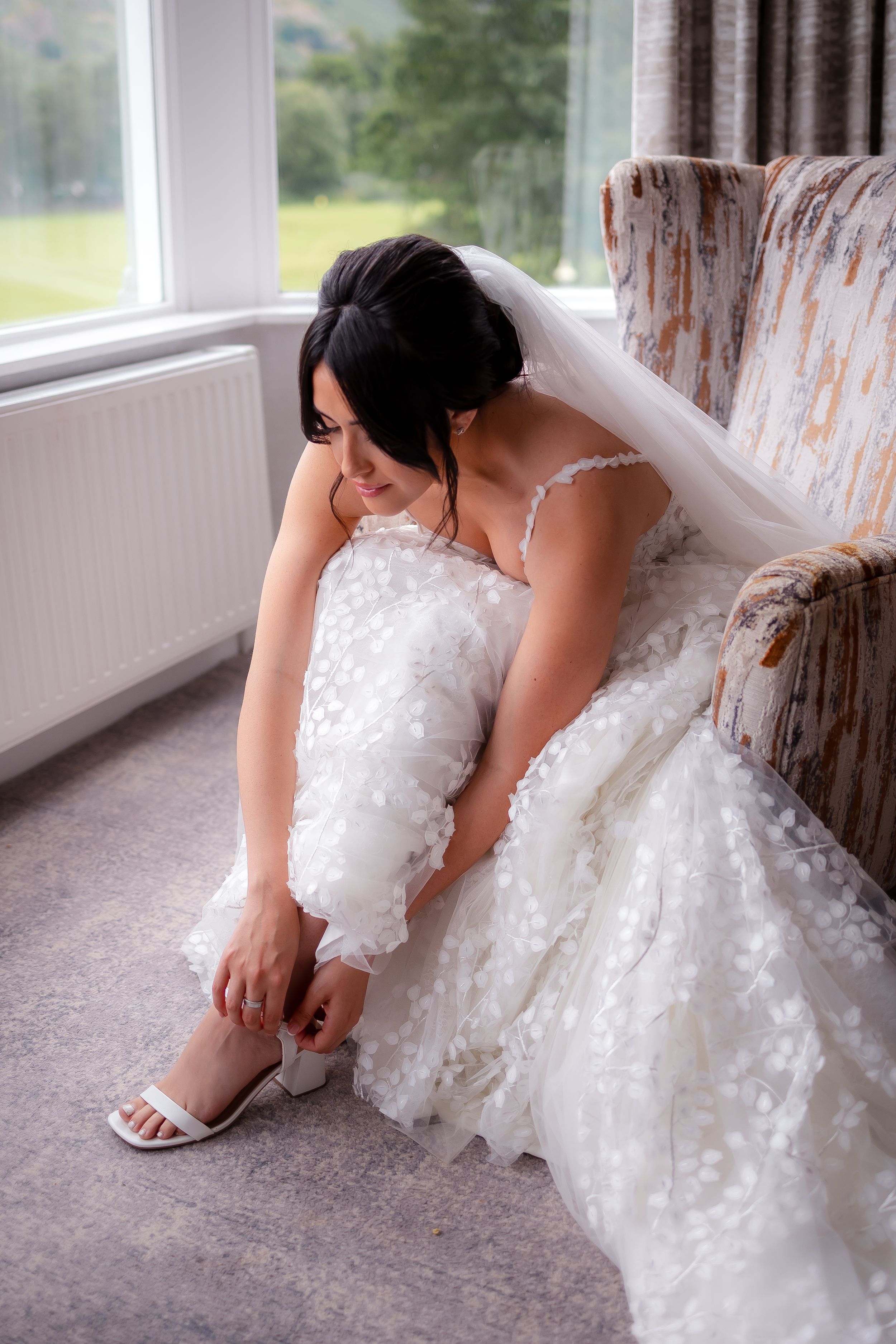 wedding photography in Cumbria - bride getting her shoes on