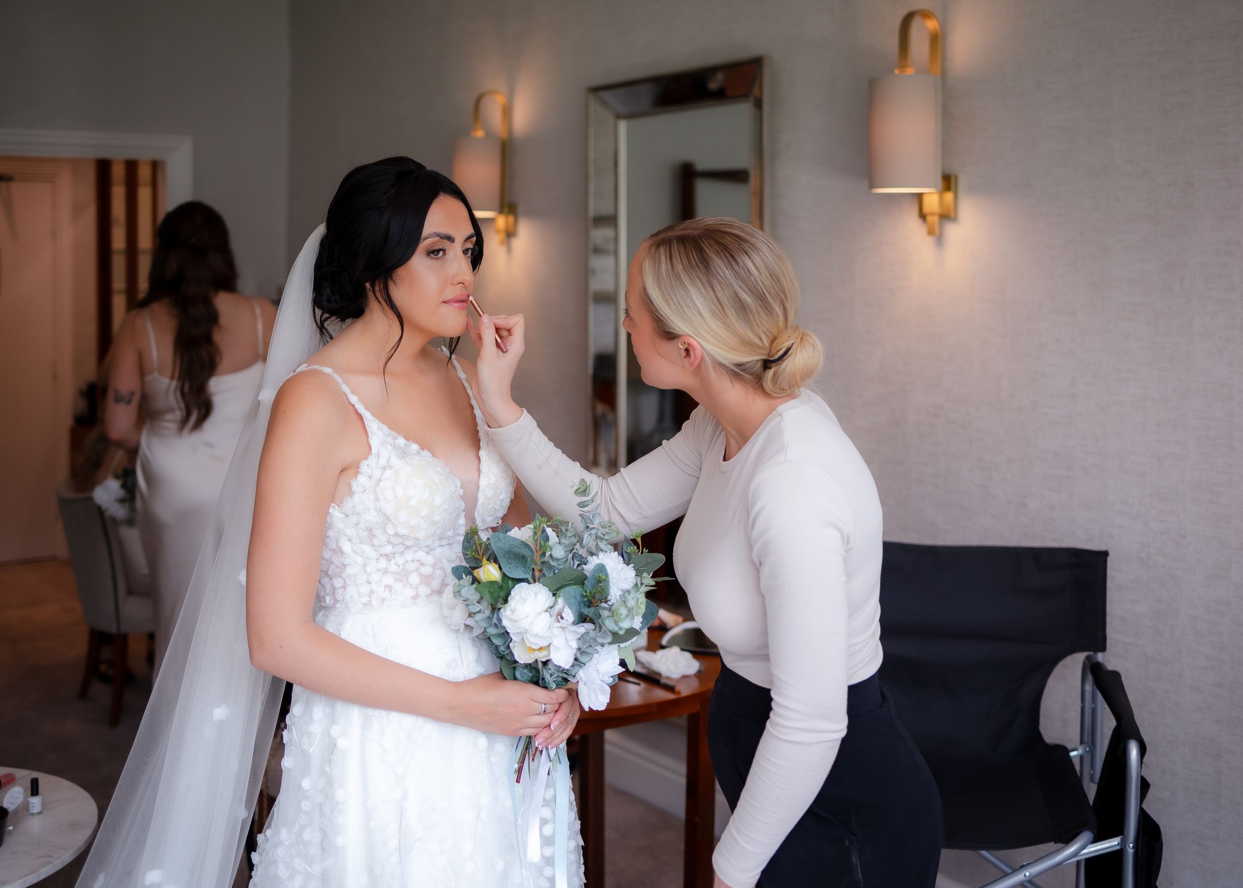 wedding photography in Cumbria  - bride getting make up final touches