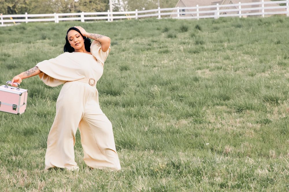 A series of romantic pastel photos showing someone in a flowing cream dress twirling and dancing in a grassy field.