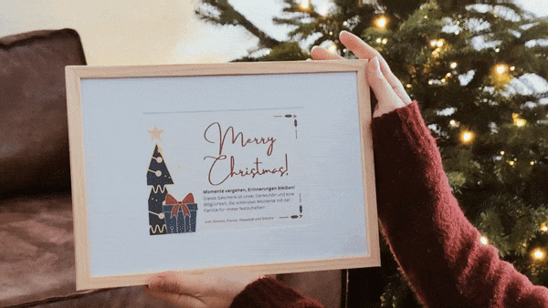 Christmas cards and decorative messages displayed near a lit tree.