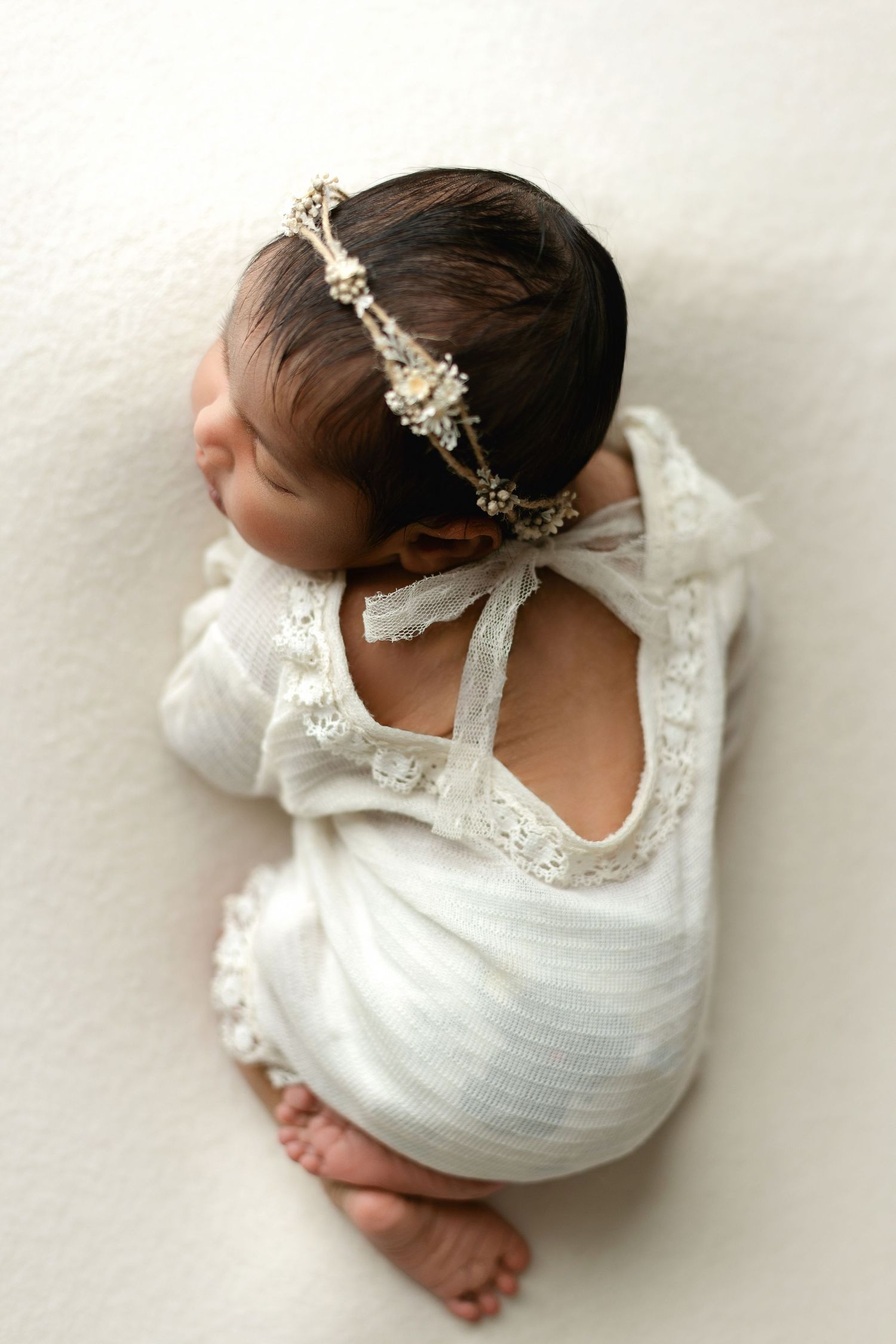 An ethnic newborn baby in a cream dress. Greenville SC newborn photographer, Easley, SC newborn photographer, Upstate newborn photographer