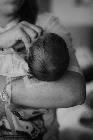 Mother holding newborn for Fresh 48 photography session captured by Maryland Fresh 48 newborn photographer Mallory Bramlett.