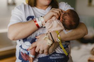 Mother holding newborn for Fresh 48 photography session captured by Maryland Fresh 48 newborn photographer Mallory Bramlett.
