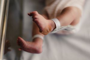 Newborn in hospital bassinet for Fresh 48 photography session captured by Maryland family photographer Mallory Bramlett.