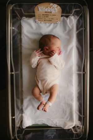 Newborn in hospital bassinet for Fresh 48 photography session captured by Maryland family photographer Mallory Bramlett.