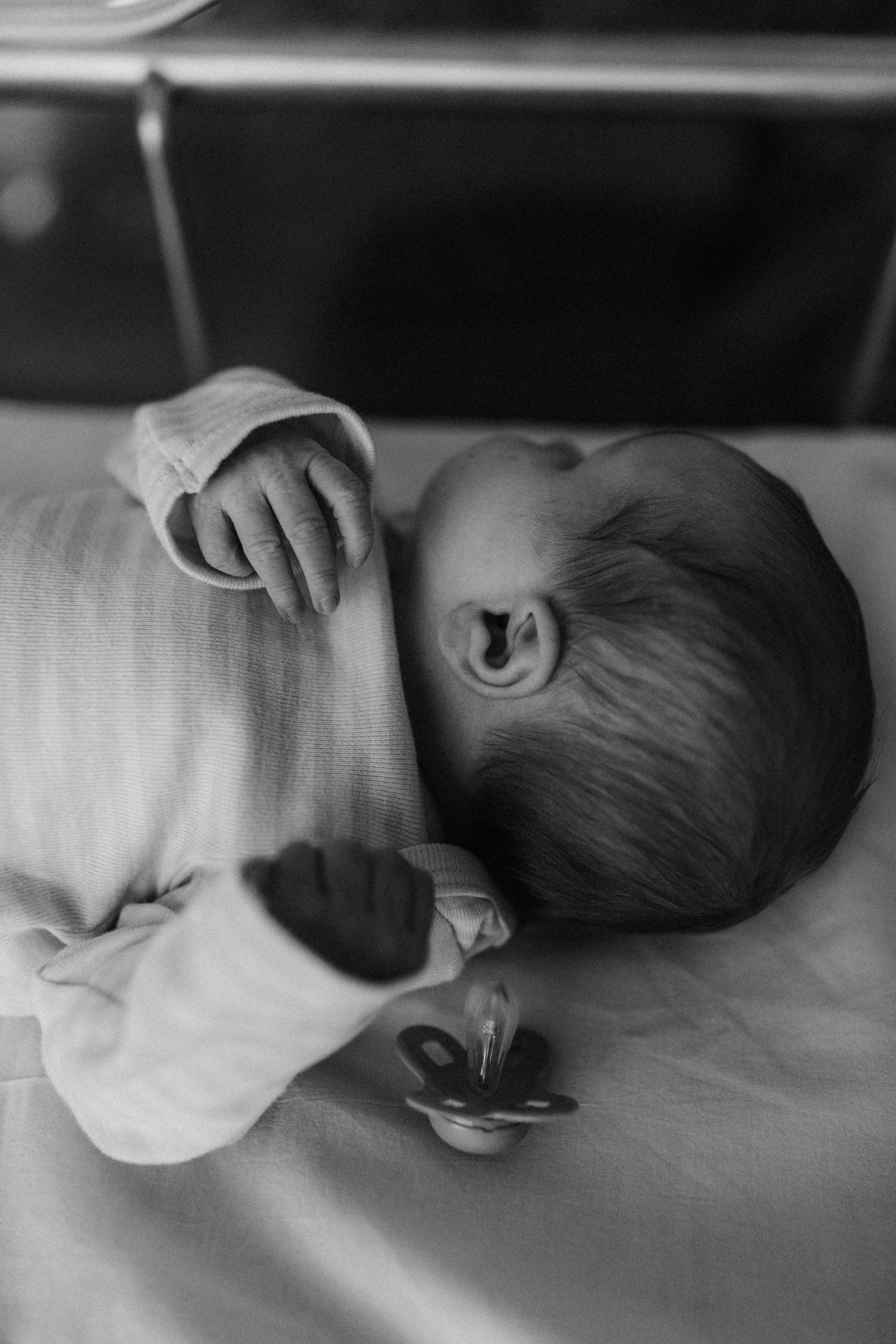 Newborn in hospital bassinet for Fresh 48 photography session captured by Maryland family photographer Mallory Bramlett.