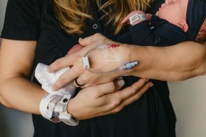 Mother holding newborn in hospital for Fresh 48 photography session captured by Maryland Fresh 48 newborn photographer Mallory Bramlett.