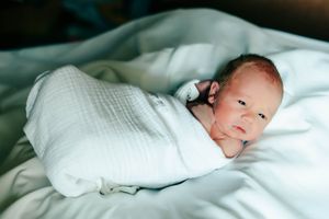 A series of photos showing a baby resting peacefully on white bedding.