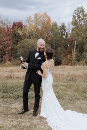 Bride and groom pop Champagne and celebrate at Farmer Brown's Greenhouse, Moncton wedding photographer, best photographer in New Brunswick
