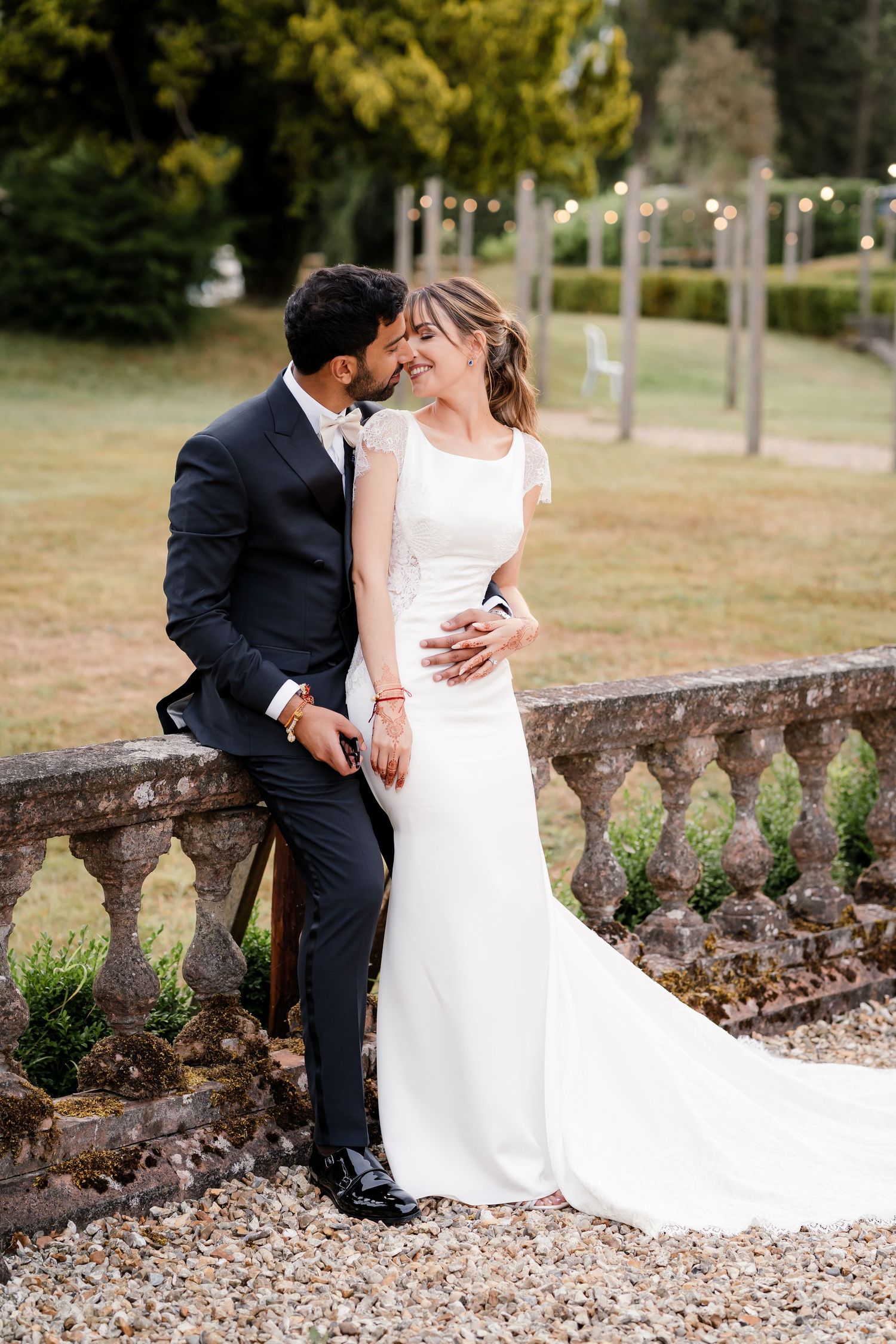 First look in British wedding outfits — bride in Pronovias gown, groom in tuxedo, fusion wedding photography