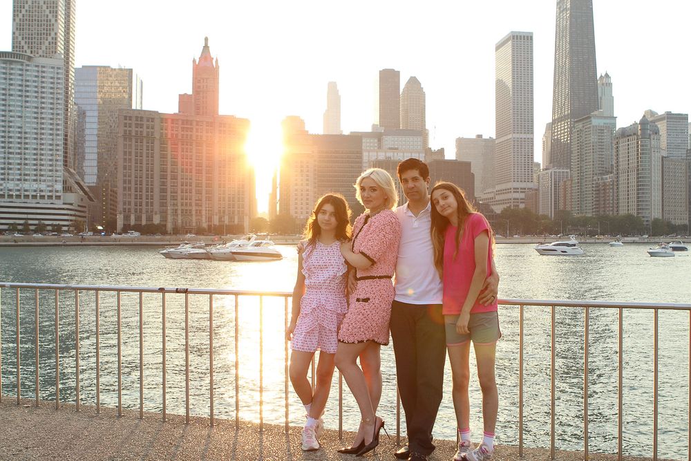 Family enjoying sunset views of Chicago skyline along Lake Michigan waterfront.