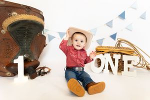 A decorative banner featuring monthly milestone photos of a baby's first year arranged in chronological order.