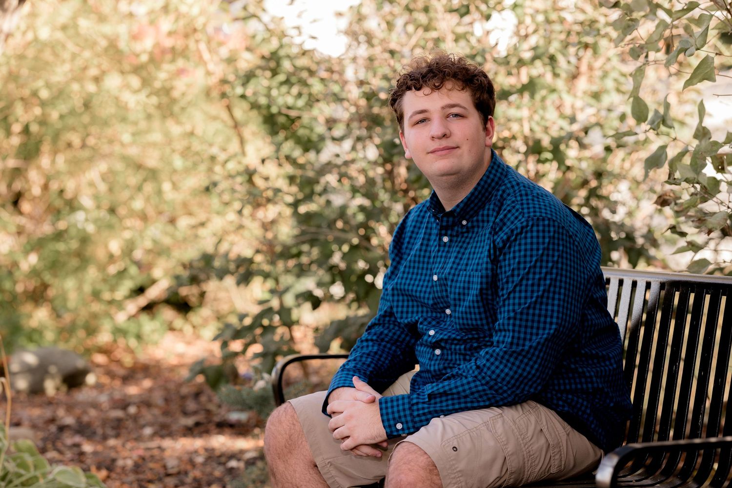 Series of casual outdoor portraits on wooden bench with fall foliage background.