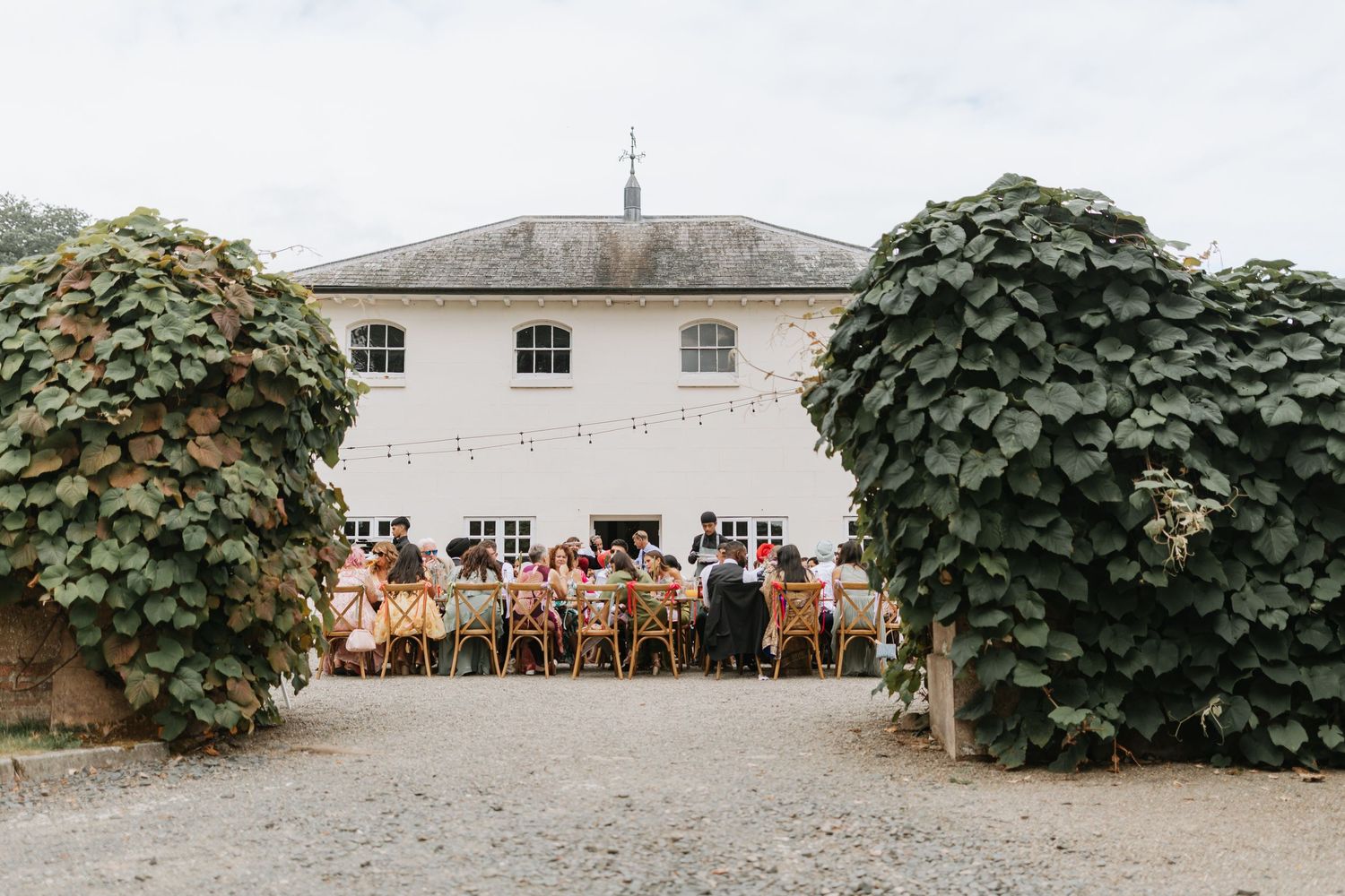 A panoramic collage of outdoor wedding venue spaces with rustic wooden chairs arranged in rows at a countryside location.