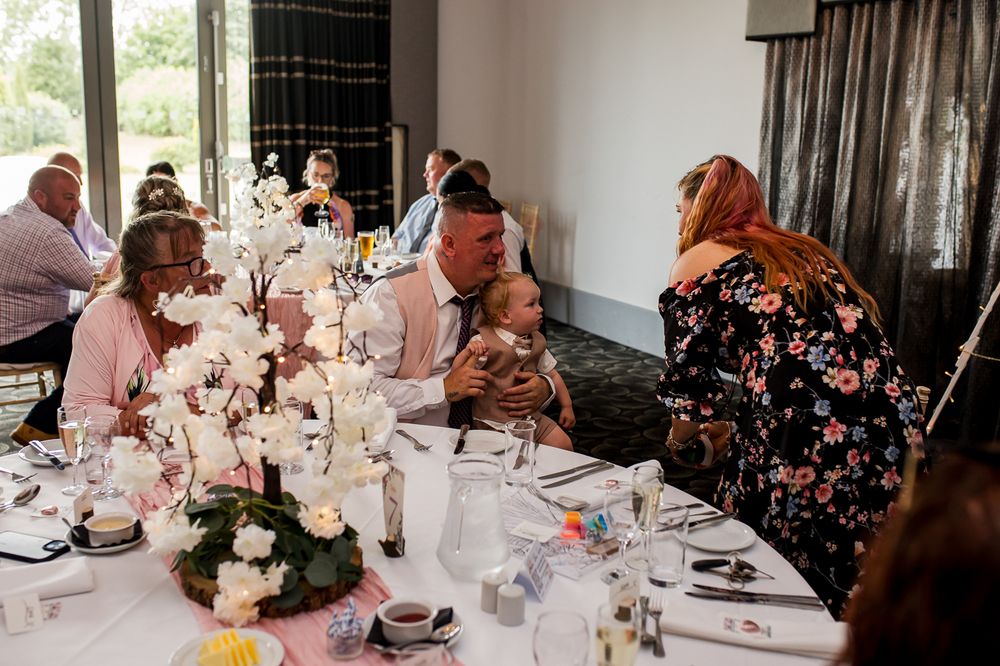 Wedding reception dining room with natural lighting and elegant table settings.