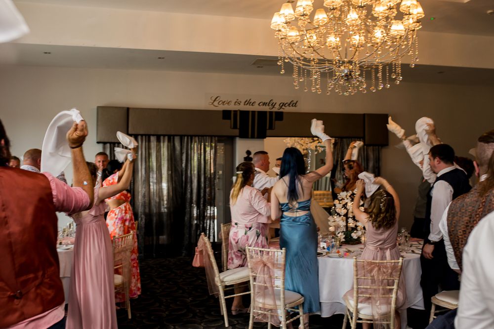 Elegant wedding venue with crystal chandelier and romantic ambient lighting.