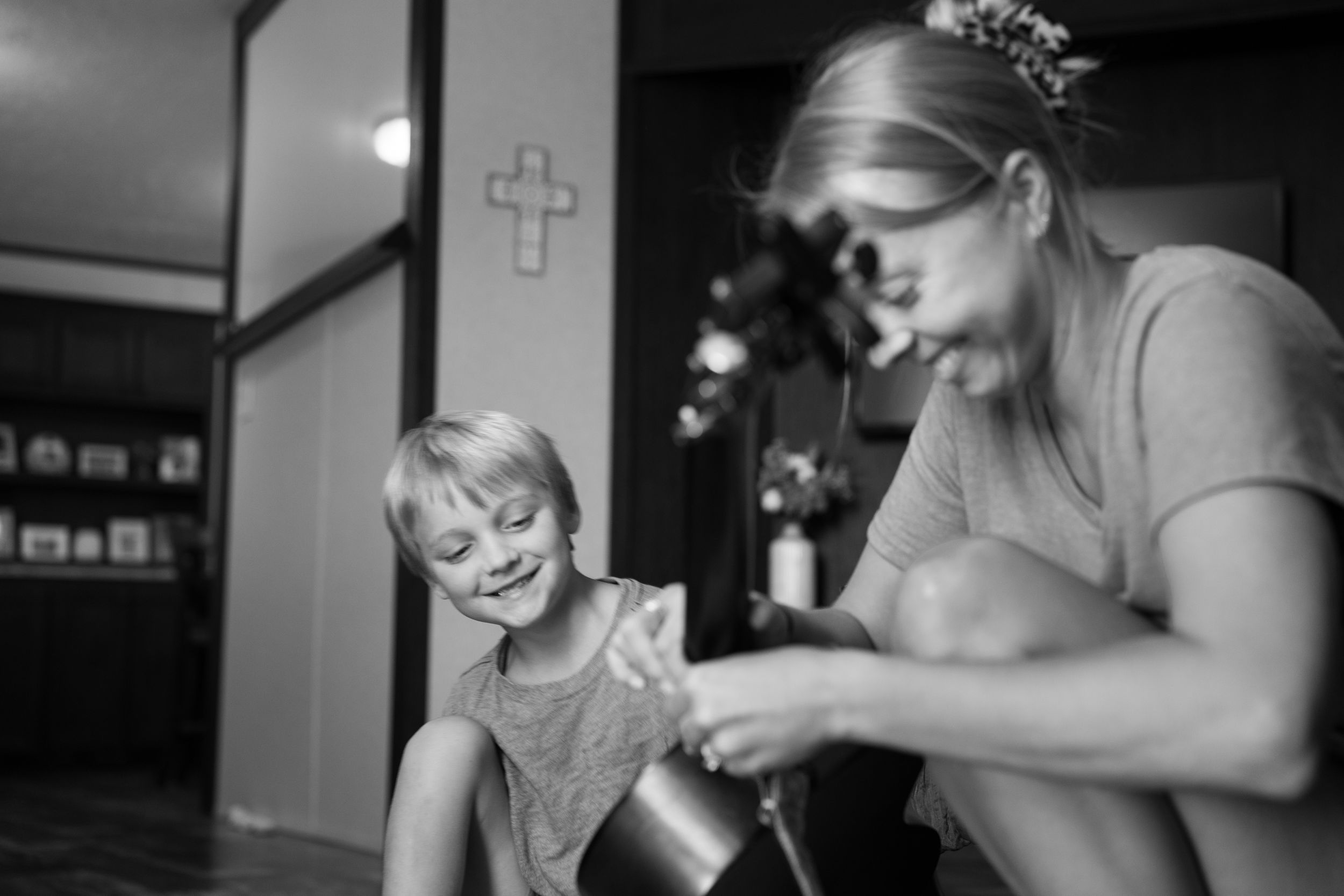 Black and white candid photo showing joyful moments between people.